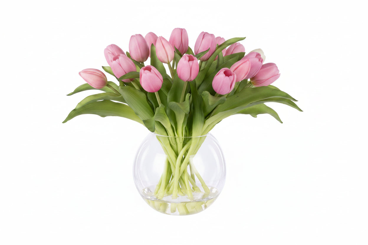 Bouquet of pink tulips in a clear glass vase on a white background