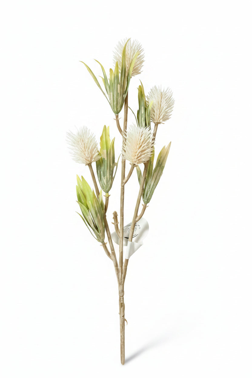 Artificial plant with white flowers on a gray surface