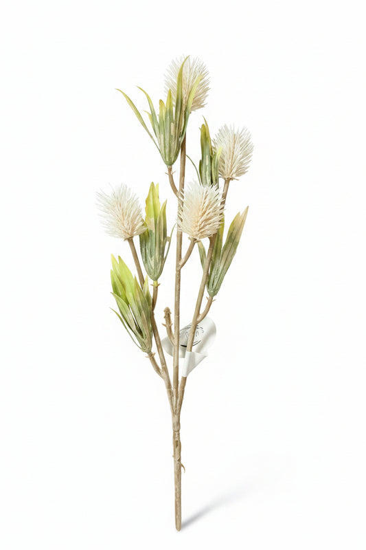 Artificial plant with white flowers on a gray surface